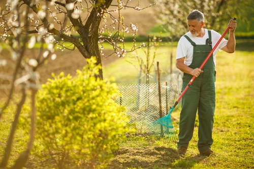 Gardener in Merton Park using PPE during outdoor maintenance work